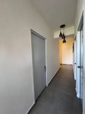 an empty hallway with a white door and a tile floor at Apartamento la familia 2 in Santa Bárbara de Samaná