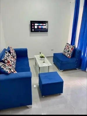 a living room with two blue couches and a table at Apartamento la familia 2 in Santa Bárbara de Samaná