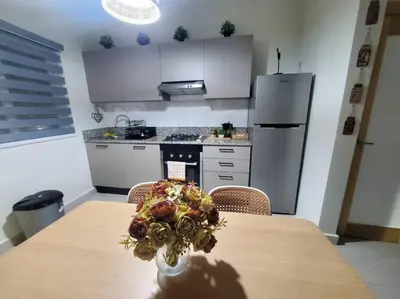 a kitchen with a table with a vase of flowers on it at Escapada en Boca chica in Boca Chica