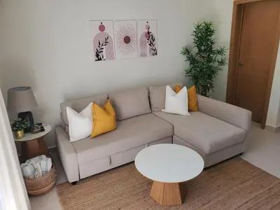 a living room with a couch and a table at Escapada en Boca chica in Boca Chica