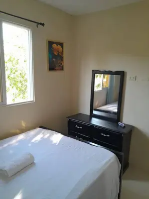 a bedroom with a bed and a dresser with a mirror at SDQ Apartamento Marbella 3 in La Ureña