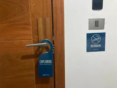 a blue sign on a door with a sign on it at Honky Tonk Punta Cana in Punta Cana