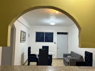 a living room with a table and chairs at Apartamento pisó 1 parqueo, piscina, terraza y más in Azua de Compostela
