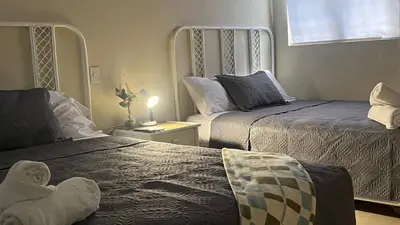 a bedroom with two beds and a teddy bear on the bed at Hotel Plaza Kavia in Santo Domingo