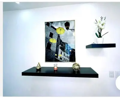 a shelf in a room with a picture on the wall at JC caribe Aparta Hotel #7 in Boca Chica