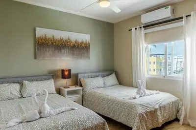 a bedroom with two beds and a window at Corte Sea A302, Luxury Penthouse in Punta Cana