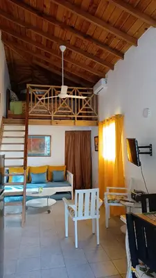 a living room with a couch and a bunk bed at Tropical Doña Mayra apartahotel in Las Terrenas