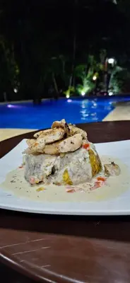 a plate of food sitting on a table at Habitación doble Villa Marchena Azua in Azua de Compostela