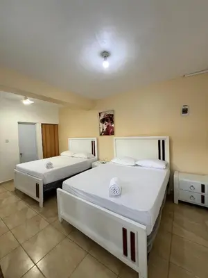 a room with two beds in a room at Habitación doble Villa Marchena Azua in Azua de Compostela