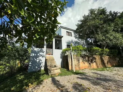 a white house with a staircase in front of it at Country home in the hills of Samana in Santa Bárbara de Samaná
