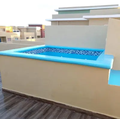 a pool in the middle of a building at Caleta in La Romana