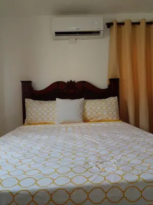a bedroom with a large bed with a wooden headboard at Caleta in La Romana