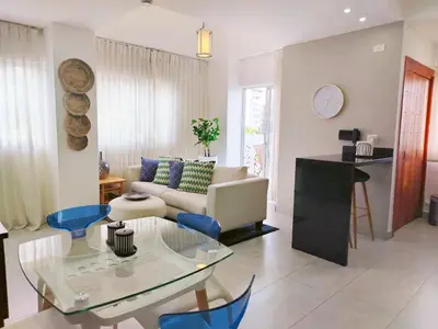 a living room with a couch and a glass table at Refa 304 in Santo Domingo