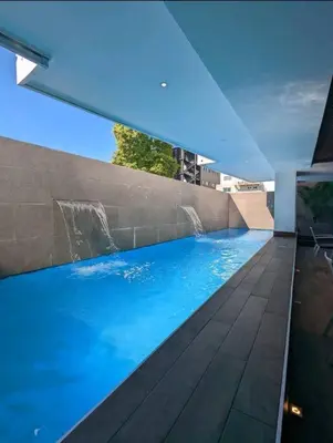 a large swimming pool in a building with aitating at Refa 304 in Santo Domingo