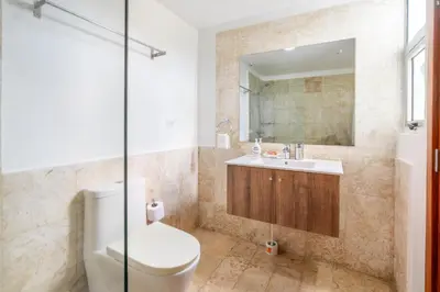 a bathroom with a toilet and a sink at 3BR apartment with beach access and ocean view in Juan Dolio