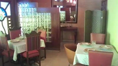 a dining room with a table and chairs in a restaurant at Hotel Tropicana Santo Domingo in La Viva