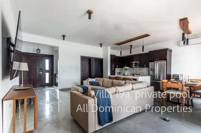a living room with a couch and a table at Sosua Ocean Village, Villas Nuevas con piscinas privadas! in Sosúa