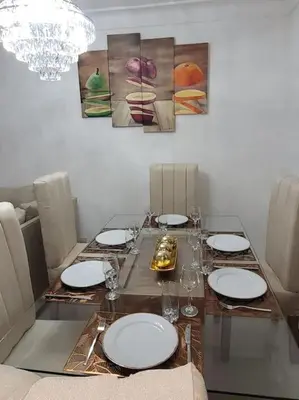 a dining room table with plates and glasses on it at El mejor alojamiento en Santiago in Santiago de los Caballeros