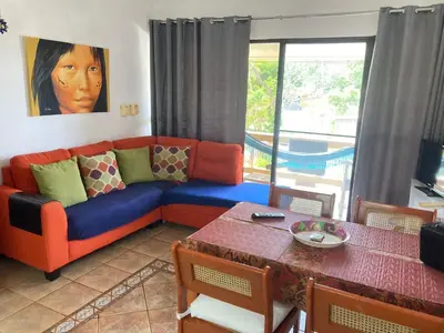 a living room with a couch and a table at Cita del Sol City Apartments in Cabarete