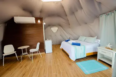 a bedroom with a bed in a tent at Hotel Don Bululo Camping Lodge in Punta Rucia