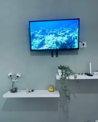 a flat screen tv hanging on a wall at Cielo de cierro-Apartment with Jacuzzi, 2 minutes from the beach in La Romana