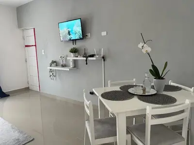 a white dining room with a white table and chairs at Cielo de cierro-Apartment with Jacuzzi, 2 minutes from the beach in La Romana