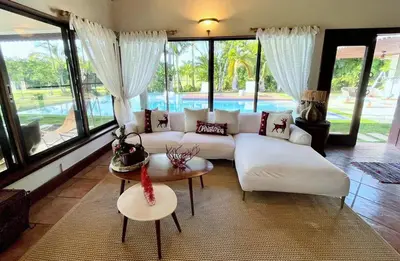 a living room with a white couch and a table at Villa Mariposa in Cajuiles