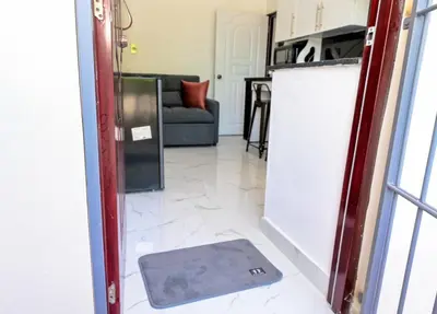 a door to a kitchen with a mat on the floor at Apartamento moderno de una habitación in San Pedro de Macorís