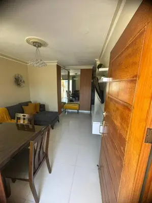 a living room with a couch and a table at Oasis en la Sultana del Este in San Pedro de Macorís