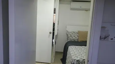 a small room with a bed and a room with a mirror at Apartamento de Lujo En San Pedro in San Pedro de Macorís