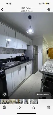 a kitchen with white cabinets and a sink and a refrigerator at Apartamento de Lujo En San Pedro in San Pedro de Macorís