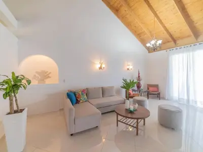 a living room with a couch and a table at Casati Pearl House, Big House With Private Pool in Bombita
