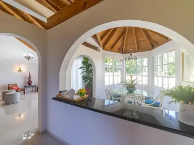 a living room with an archway and a dining room at Casati Pearl House, Big House With Private Pool in Bombita