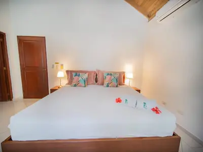 a bedroom with a large white bed with pillows at Casati Pearl House, Big House With Private Pool in Bombita