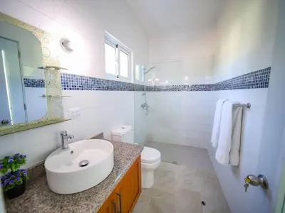 a white bathroom with a sink and a toilet at 8br Private Villa In Sosa - 2 Mins From Nightlife in Sosúa