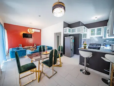 a kitchen and living room with a blue couch at 8br Private Villa In Sosa - 2 Mins From Nightlife in Sosúa