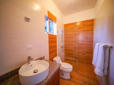 a bathroom with a sink and a toilet at 8br Private Villa In Sosa - 2 Mins From Nightlife in Sosúa