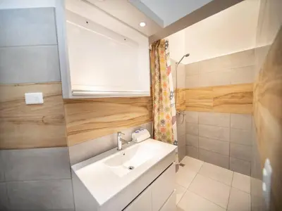 a small bathroom with a sink and a mirror at Cozy 1 Bedroom Apartment in Heart of Sosa in Sosúa