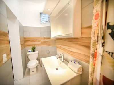 a small bathroom with a toilet and a sink at Cozy 1 Bedroom Apartment in Heart of Sosa in Sosúa