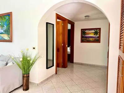 a hallway with a room with a bed and a mirror at Casati Family House, Great Pool Garden in Sosúa