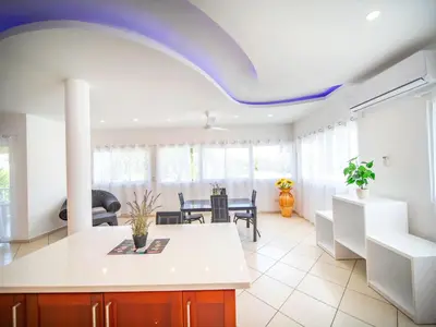 a kitchen and dining room with a blue ceiling at 2BR Luxury Apartment in Heart Of Nightlife Area in Sosúa