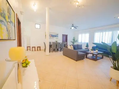 a living room with a couch and a table at 7br Massive Villa In Sosa - 2mins From Nightlife in Sosúa