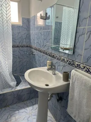 a bathroom with a sink and a mirror at Playa Azul House in Bayahibe