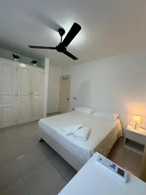 a bedroom with a bed and a ceiling fan at Playa Azul House in Bayahibe