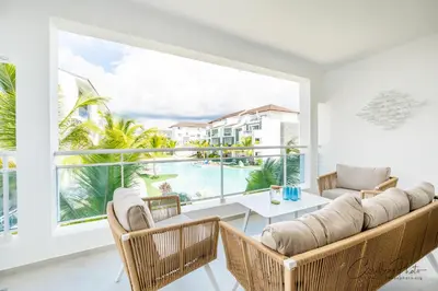 a living room with a table and chairs and a large window at Estrella Dominicus deluxe Apartment in La Laguna