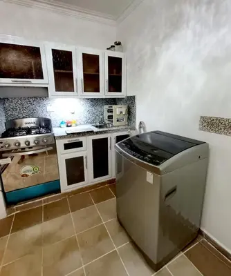 a small kitchen with a stove and a refrigerator at Cozy & Spacious Apartament Boca Chica Beach in Boca Chica