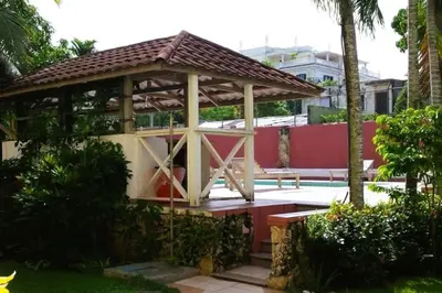 a pavilion with a picnic table in a garden at Cozy & Spacious Apartament Boca Chica Beach in Boca Chica