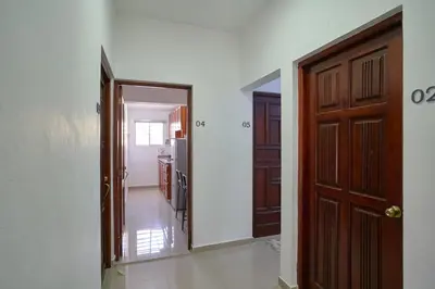 an empty hallway with a door and a kitchen at Escape Studio Close to Agora Mall in Santo Domingo