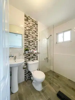 a bathroom with a toilet and a sink and a shower at Escape Studio Close to Agora Mall in Santo Domingo
