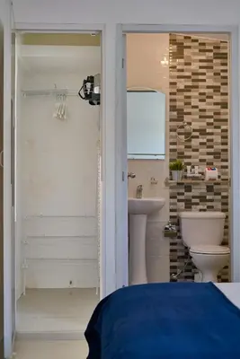 a bathroom with a toilet and a sink at Escape Studio Close to Agora Mall in Santo Domingo